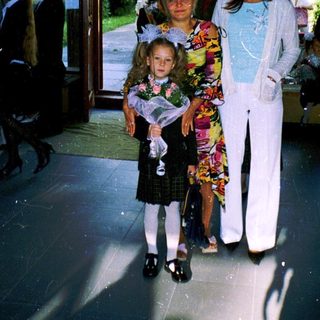 Family posing outside a building entrance.