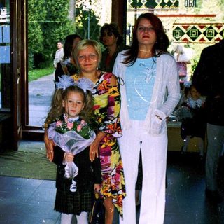 Family posing outside a building entrance.
