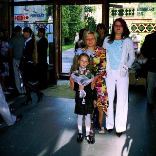 Family posing outside a building entrance.
