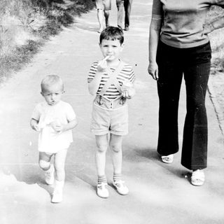 Family walking outdoors on a sunny day.
