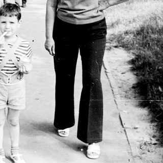 Family walking outdoors on a sunny day.