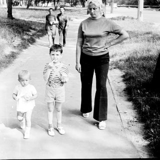 Family walking outdoors on a sunny day.