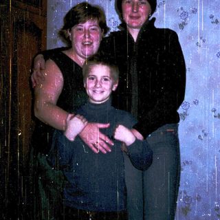 Family group photo taken indoors during rain.