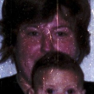 A woman holding a baby indoors.