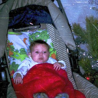 Baby in sleeper by snowy window.