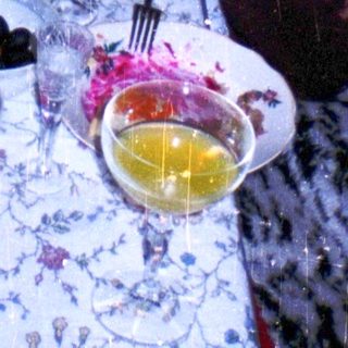 Boy holding toy gun at festive table.