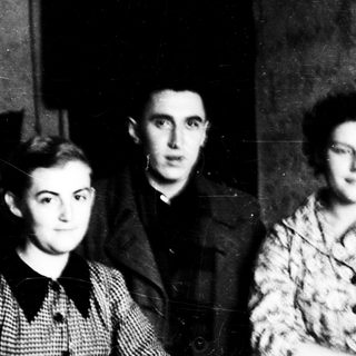 Three individuals in early-to-mid 20th-century clothing.