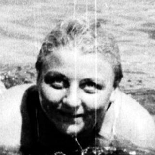 Person swimming in ocean with waves.