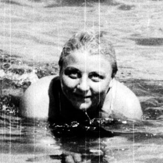 Person swimming in ocean with waves.