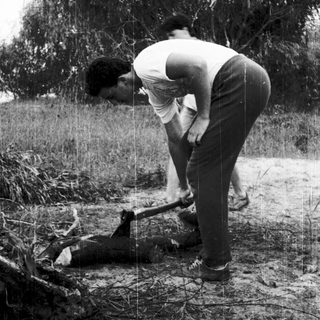 Two men assisting a fallen person outdoors.