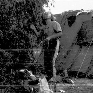 Refugee camp scene with person and dog.
