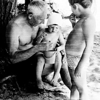 Family enjoying beach outing near water.