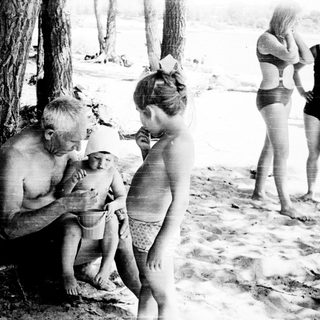 Family enjoying beach outing near water.