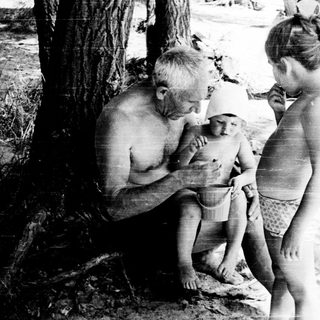 Family enjoying beach outing near water.