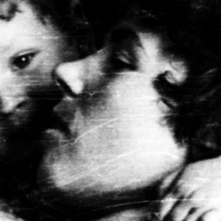 Tender embrace between two children indoors.