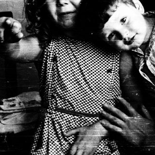 Family moment indoors with affectionate embrace.