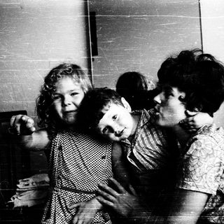 Family moment indoors with affectionate embrace.