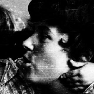 Family moment indoors with affectionate embrace.