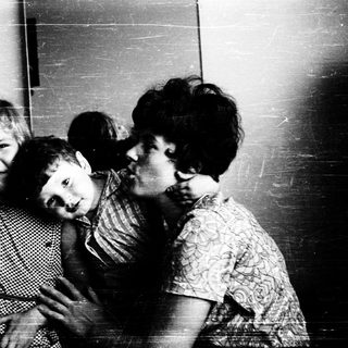 Family moment indoors with affectionate embrace.