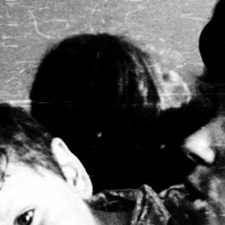 Family moment indoors with affectionate embrace.