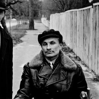 Two men posing outdoors in vintage winter attire.
