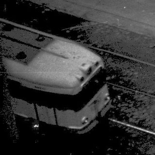Street repair with workers, machinery, and vehicles.