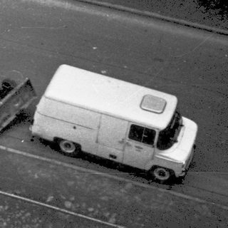 Street repair with workers, machinery, and vehicles.