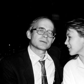 Two adults posing closely in formal attire.