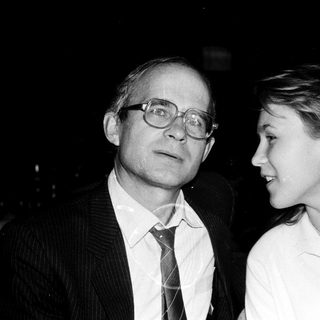 Two adults posing closely in formal attire.