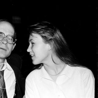 Two adults posing closely in formal attire.