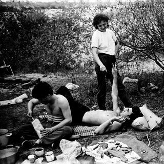 Family picnic in natural outdoor setting.