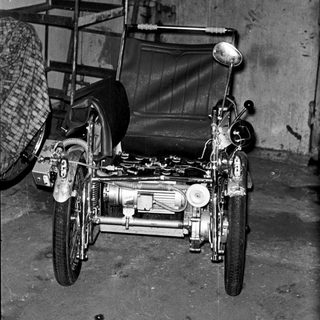 Vintage motorcycle with sidecar in garage.