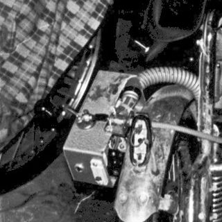 Vintage motorcycle sidecar with exposed engine.