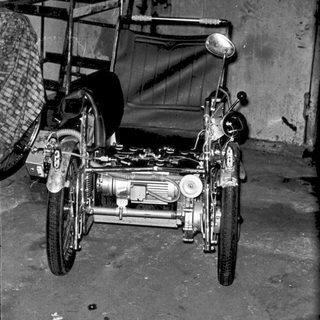 Vintage motorcycle sidecar with exposed engine.