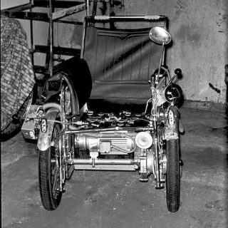 Vintage motorcycle with sidecar in workshop.