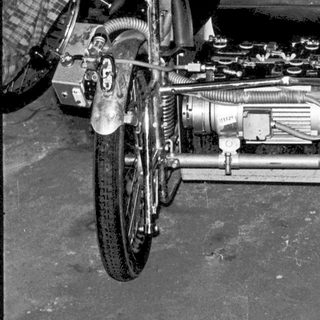 Vintage motorcycle with sidecar in workshop.
