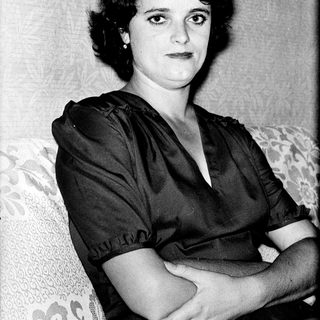 Portrait of a woman in 1940s-style clothing.