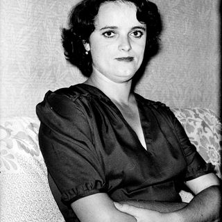 Portrait of a woman in 1940s-style clothing.