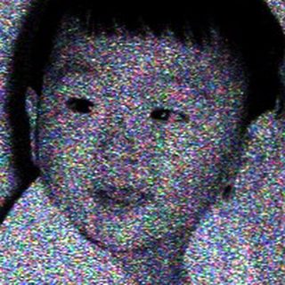 Child lying on bed in nighttime setting.