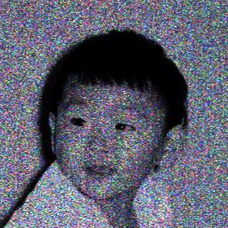 Child lying on bed in nighttime setting.