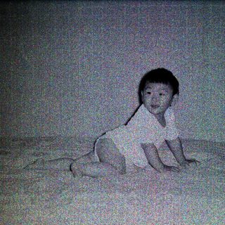 Child lying on bed in nighttime setting.