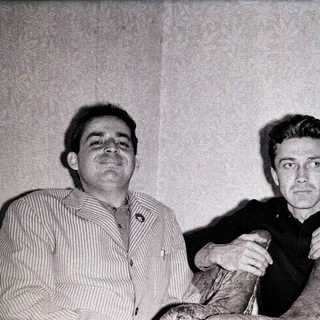Three men posing together in a vintage photograph.