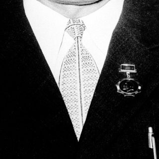 Portrait of an older man in formal attire with mustache.
