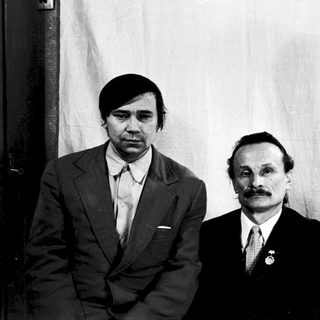 Three individuals in formal attire, mid-20th century.