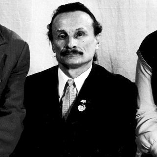 Three individuals in formal attire, mid-20th century.