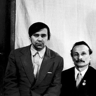 Three individuals in formal attire, mid-20th century.