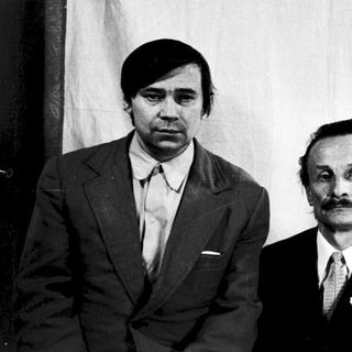 Three individuals in formal attire, mid-20th century.