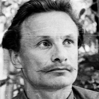 Man in outdoor setting, mid-century black-and-white portrait.