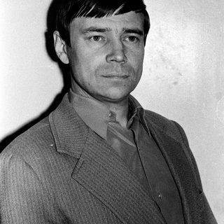 Portrait of a man in a suit, mid-20th century style.