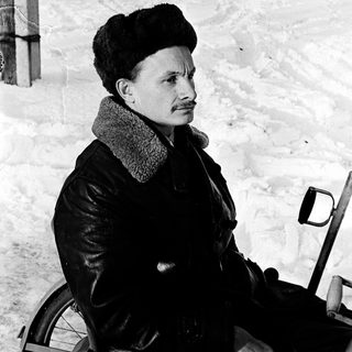 Person in winter attire riding snow-covered path.
